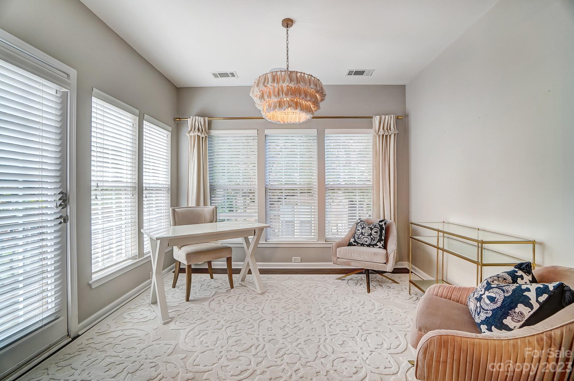 231 Lincoln Street Charlotte, NC 28203 - Photo 20 of 48 a living room with furniture and floor to ceiling windows