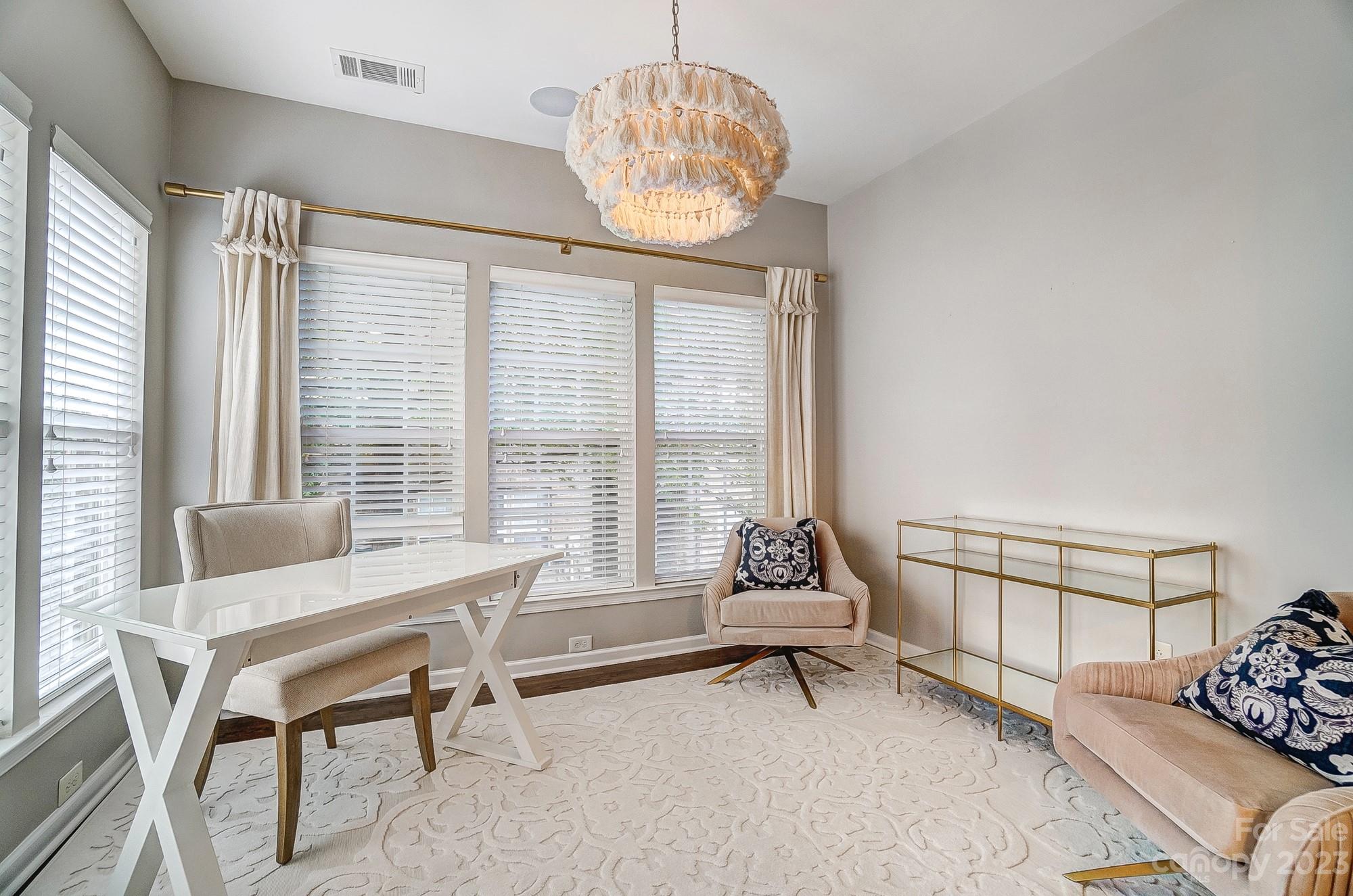 231 Lincoln Street Charlotte, NC 28203 - Photo 22 of 48 a living room with furniture and a chandelier