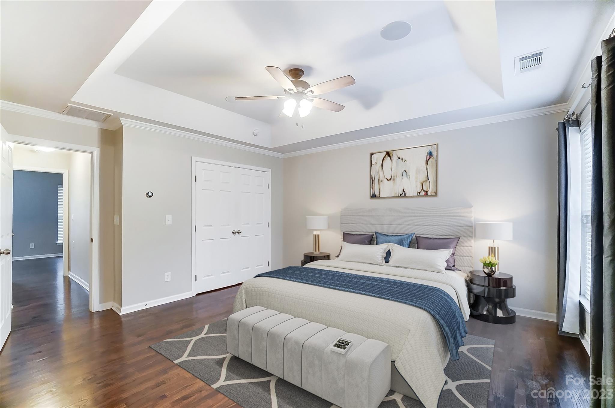231 Lincoln Street Charlotte, NC 28203 - Photo 25 of 48 a bedroom with a bed and a ceiling fan