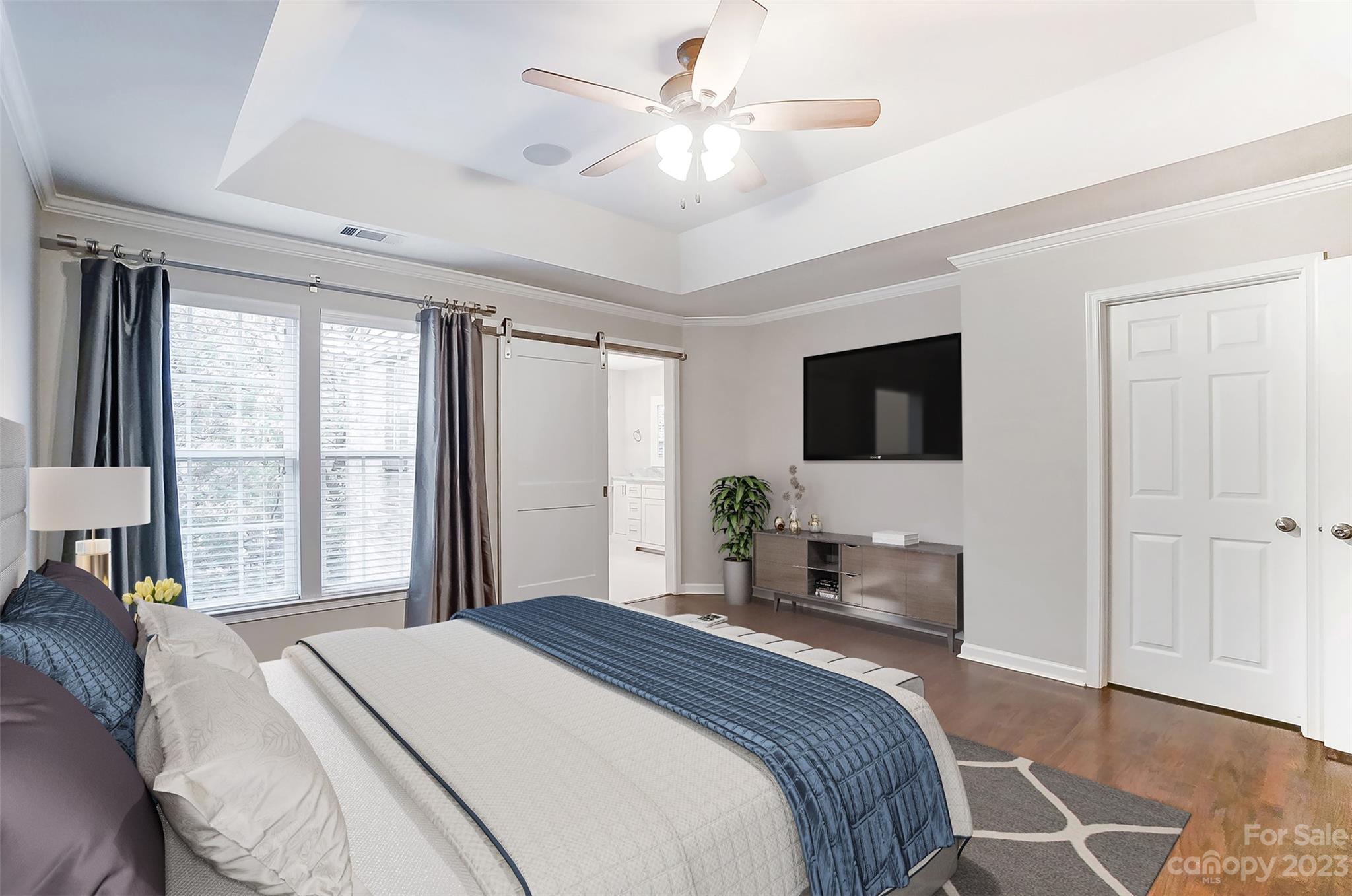 231 Lincoln Street Charlotte, NC 28203 - Photo 27 of 48 a bedroom with a bed window and a flat screen tv