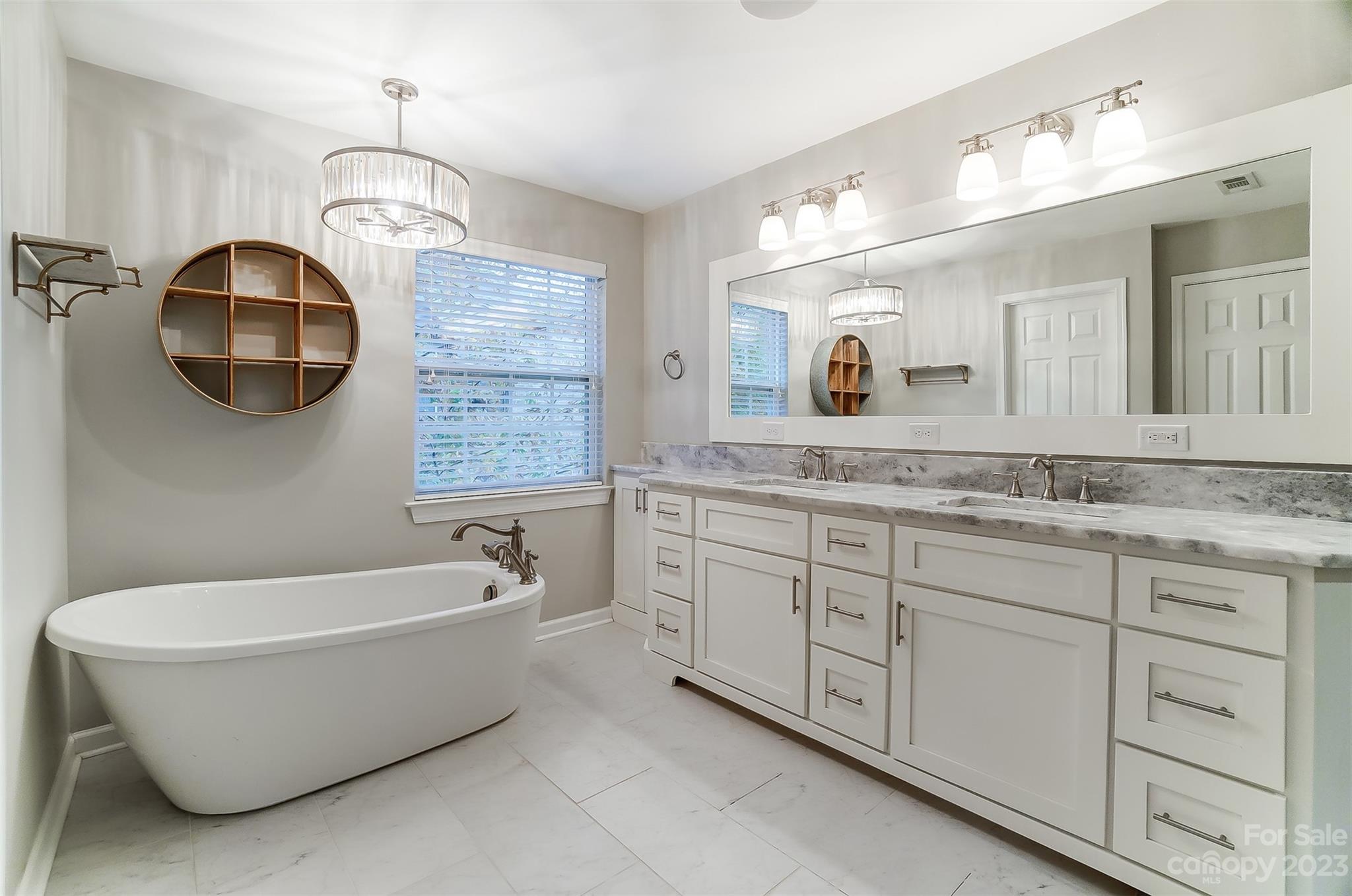 231 Lincoln Street Charlotte, NC 28203 - Photo 28 of 48 a bathroom with a granite countertop sink mirror and bathtub