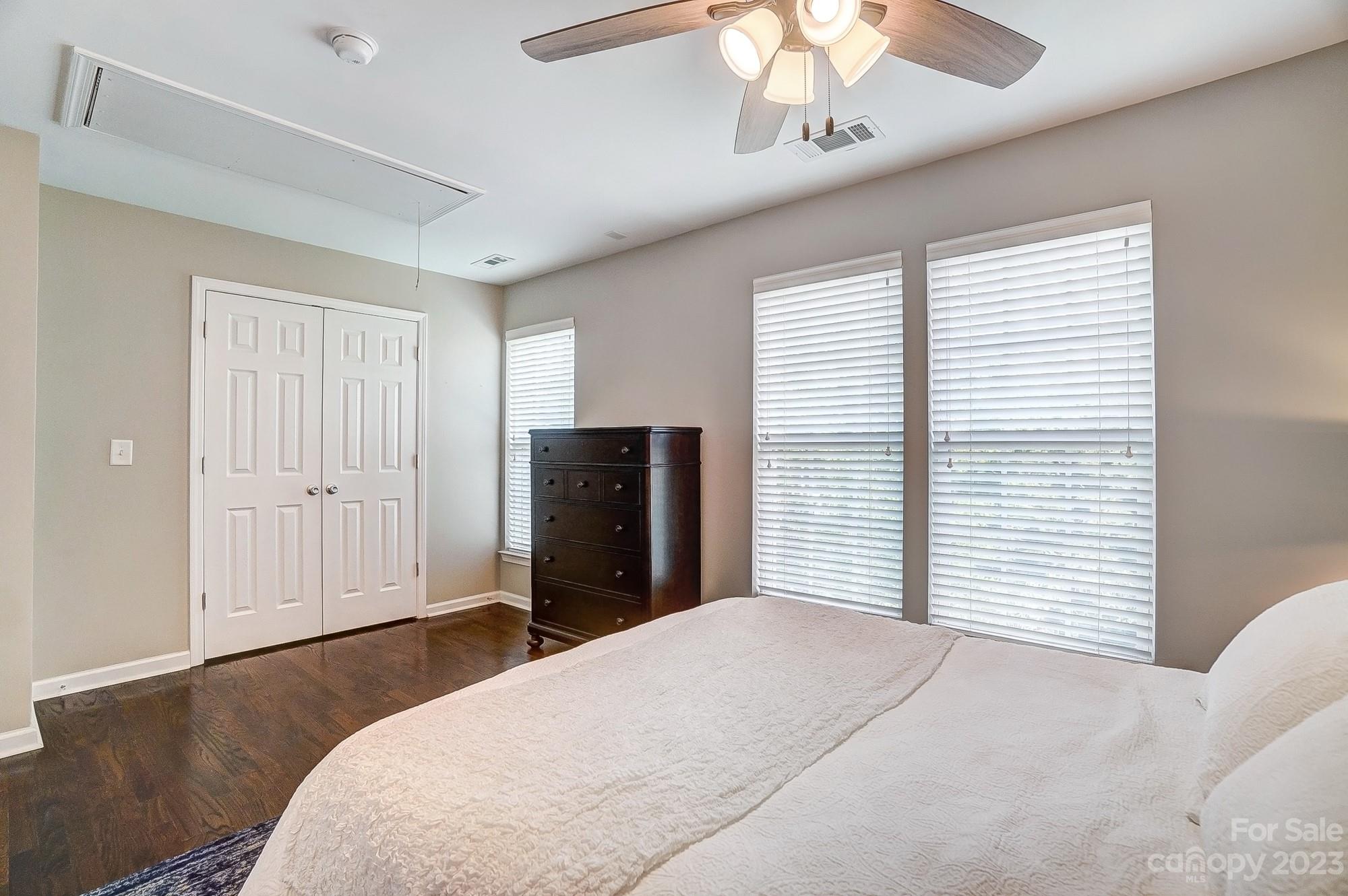 231 Lincoln Street Charlotte, NC 28203 - Photo 34 of 48 a bedroom with a large bed and a chandelier