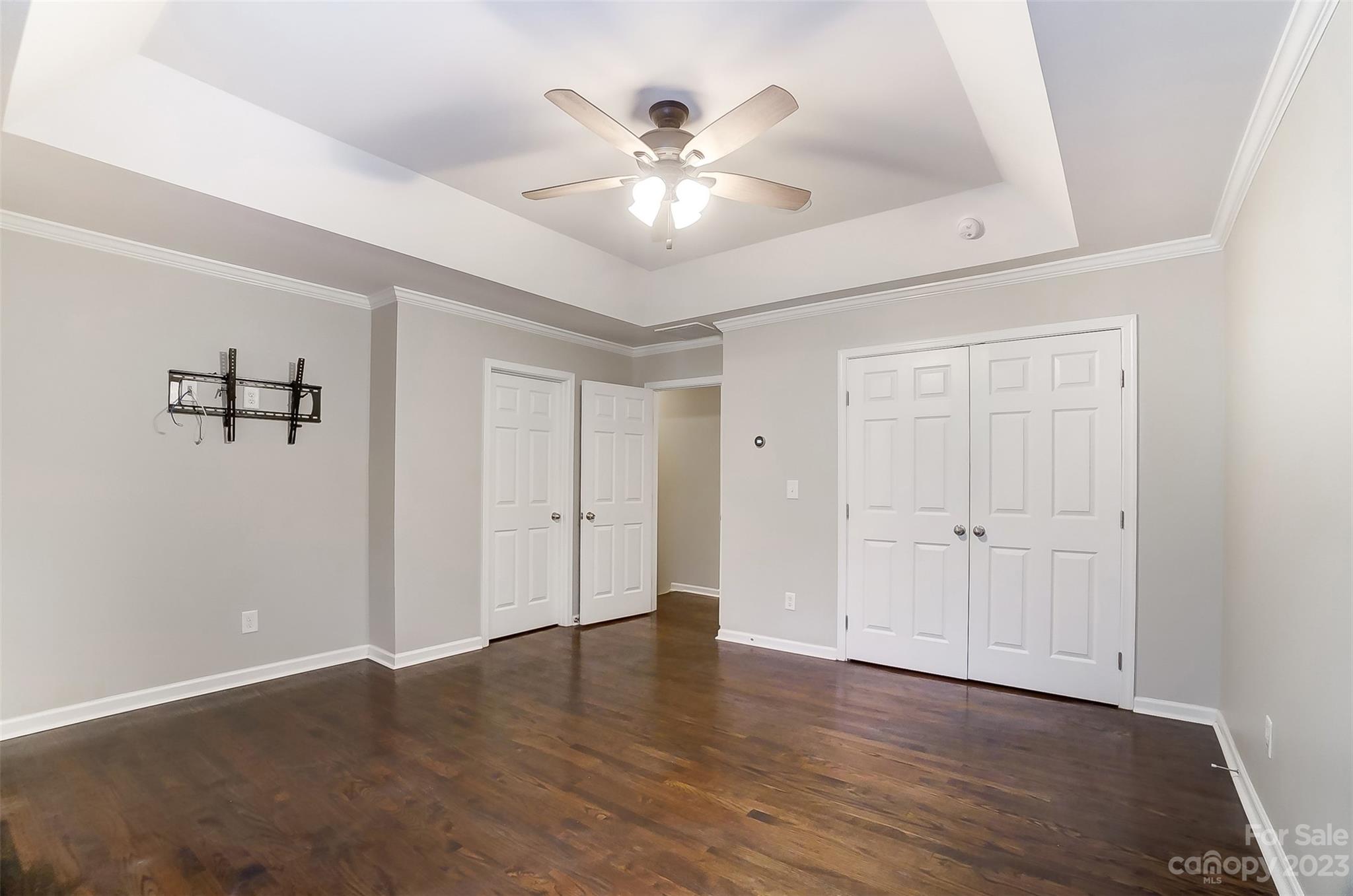 231 Lincoln Street Charlotte, NC 28203 - Photo 39 of 48 an empty room with wooden floor ceiling fan and windows