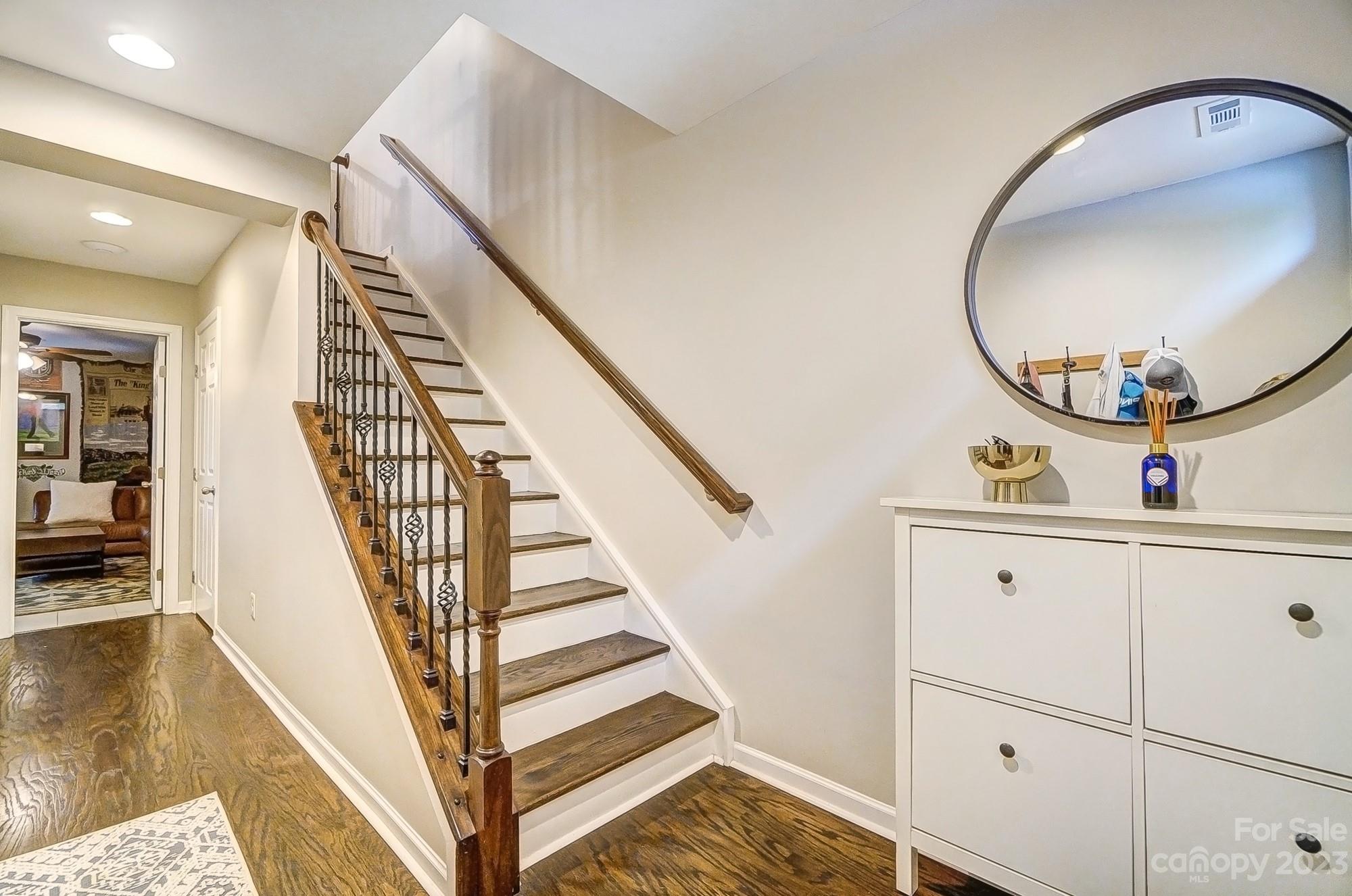 231 Lincoln Street Charlotte, NC 28203 - Photo 4 of 48 a view of a hallway with wooden floor and staircase