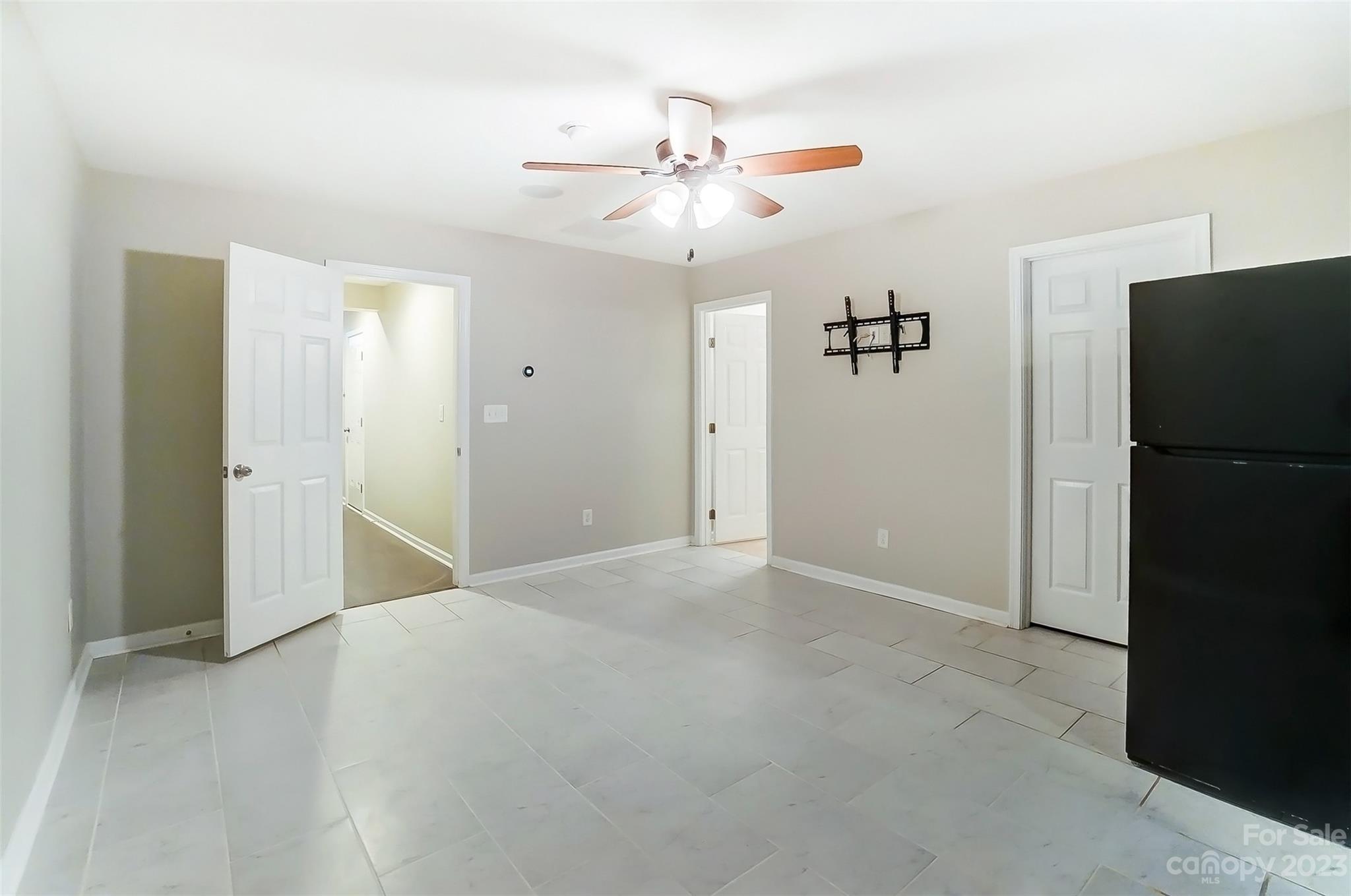 231 Lincoln Street Charlotte, NC 28203 - Photo 43 of 48 an empty room with a closet and chandelier fan