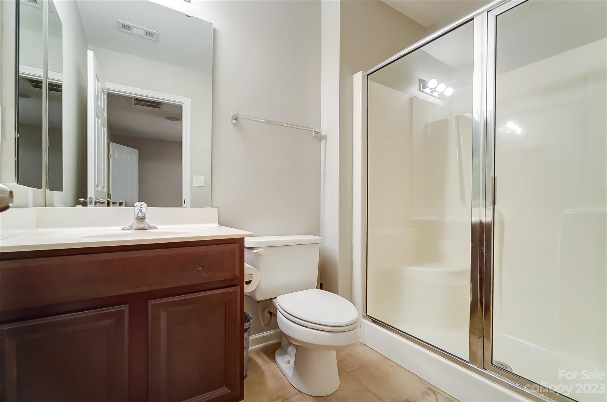231 Lincoln Street Charlotte, NC 28203 - Photo 44 of 48 a bathroom with a sink a toilet and shower