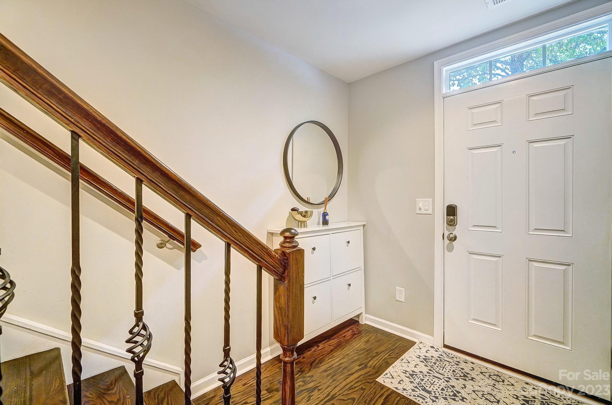 231 Lincoln Street Charlotte, NC 28203 - Photo 5 of 48 a view of a hallway with wooden floor and staircase