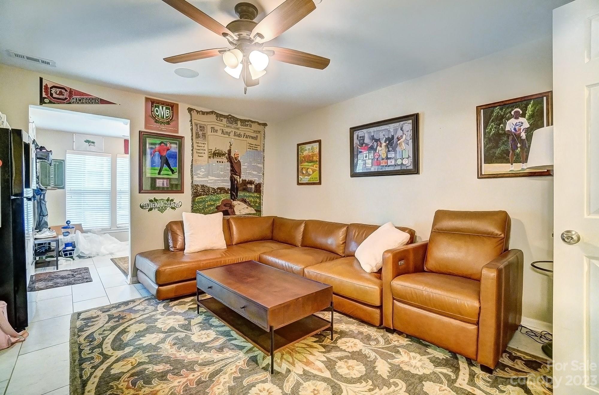 231 Lincoln Street Charlotte, NC 28203 - Photo 6 of 48 a living room with furniture a ceiling fan and a rug