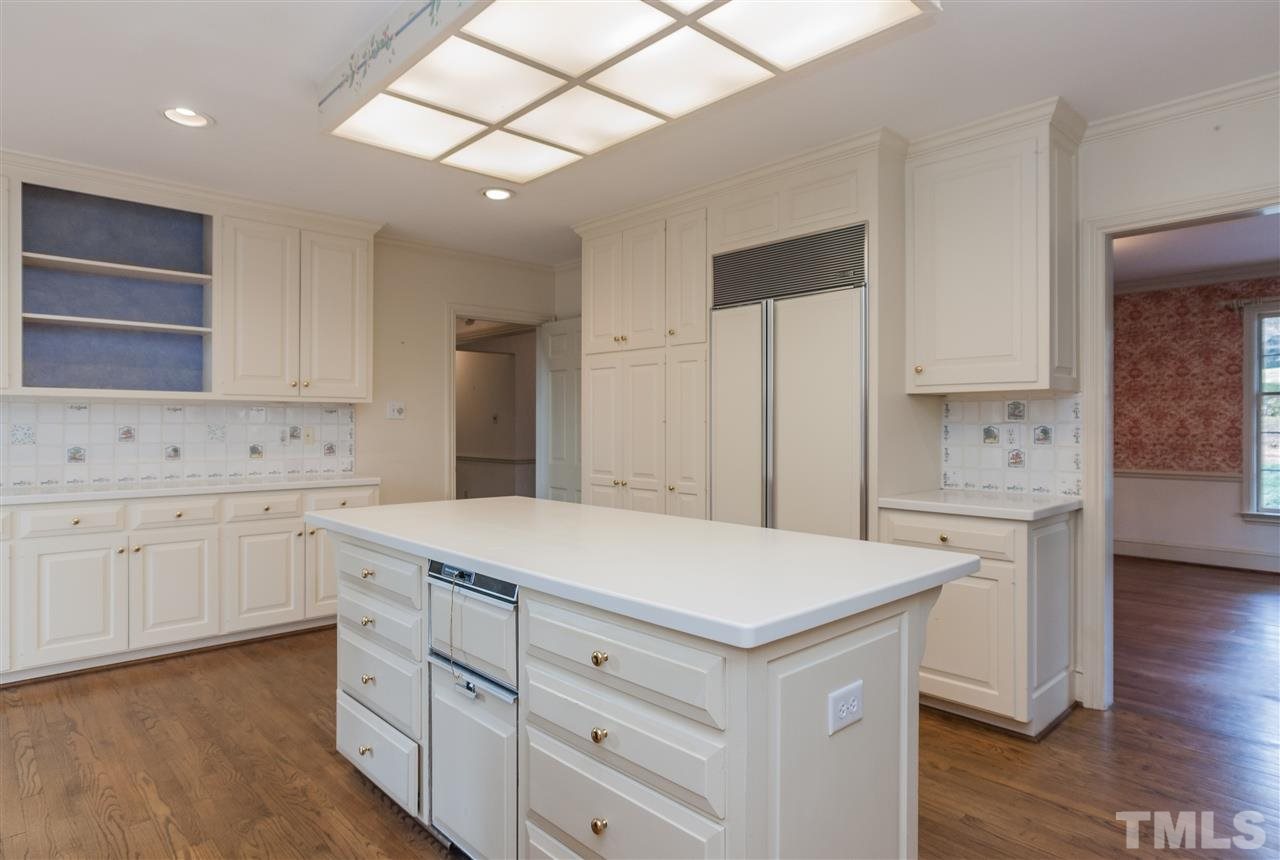 3400 Landor Road Raleigh, NC 27609 - Photo 12 of 25 a kitchen with white cabinets and sink