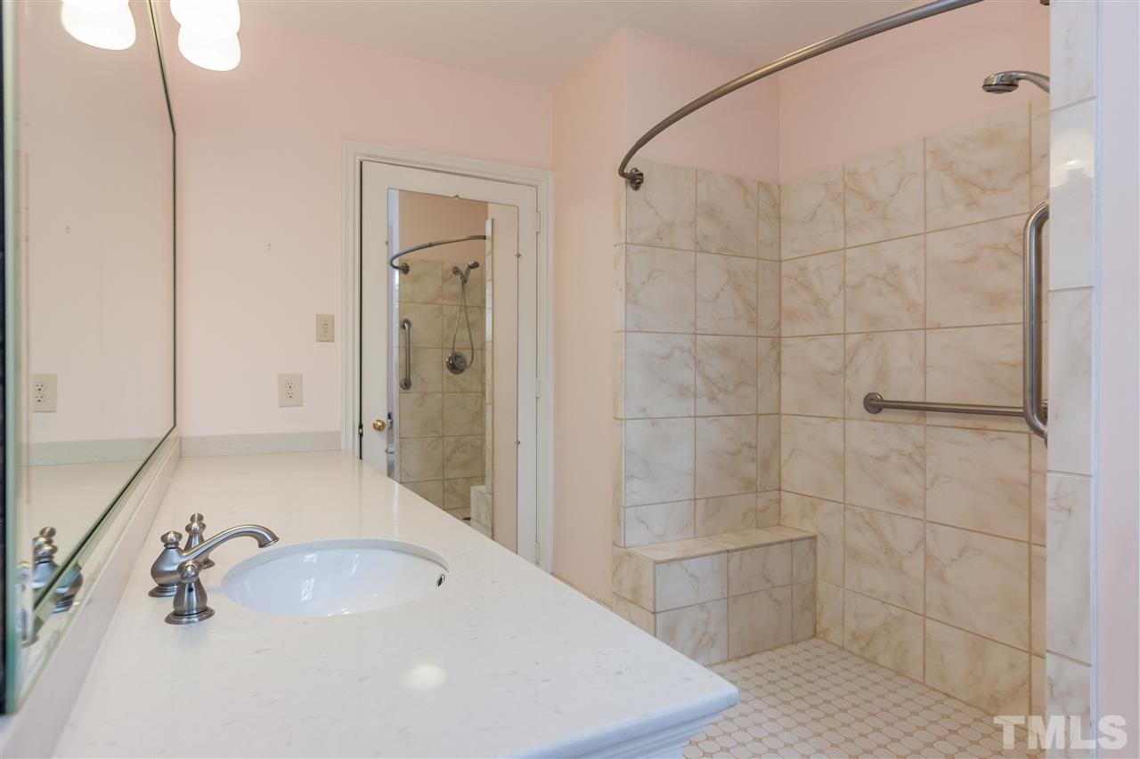 3400 Landor Road Raleigh, NC 27609 - Photo 16 of 25 a bathroom with a bathtub and shower
