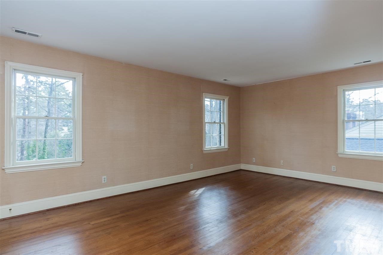 3400 Landor Road Raleigh, NC 27609 - Photo 17 of 25 a view of an empty room with wooden floor and a window