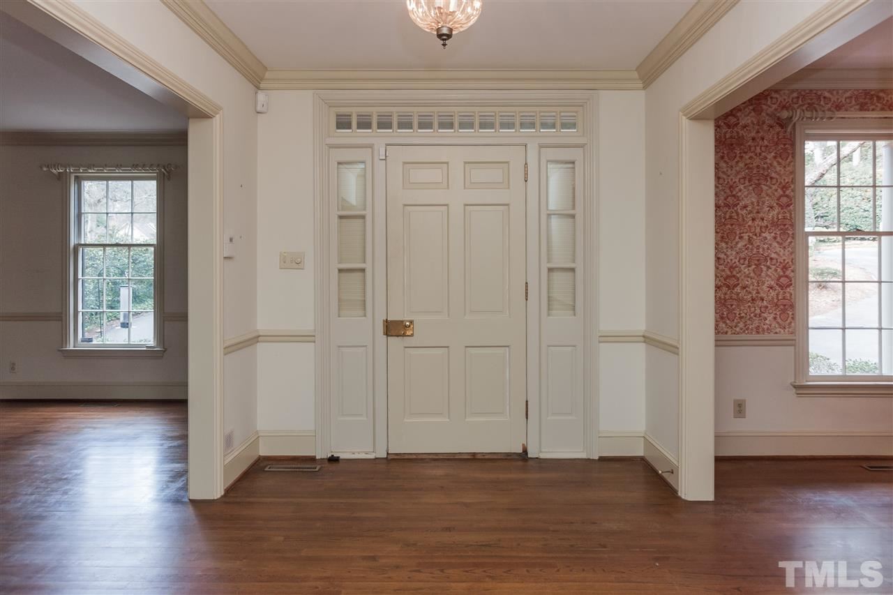 3400 Landor Road Raleigh, NC 27609 - Photo 3 of 25 an empty room with wooden floor cabinet and windows