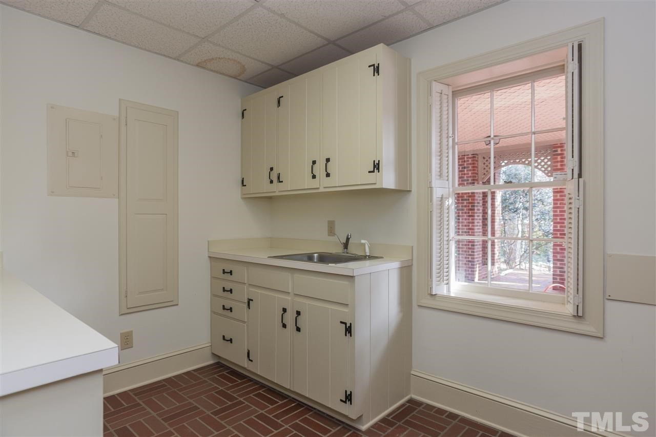 3400 Landor Road Raleigh, NC 27609 - Photo 22 of 25 a view of cabinets a sink and a window in a room
