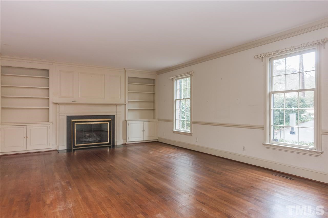 3400 Landor Road Raleigh, NC 27609 - Photo 4 of 25 an empty room with windows and fireplace