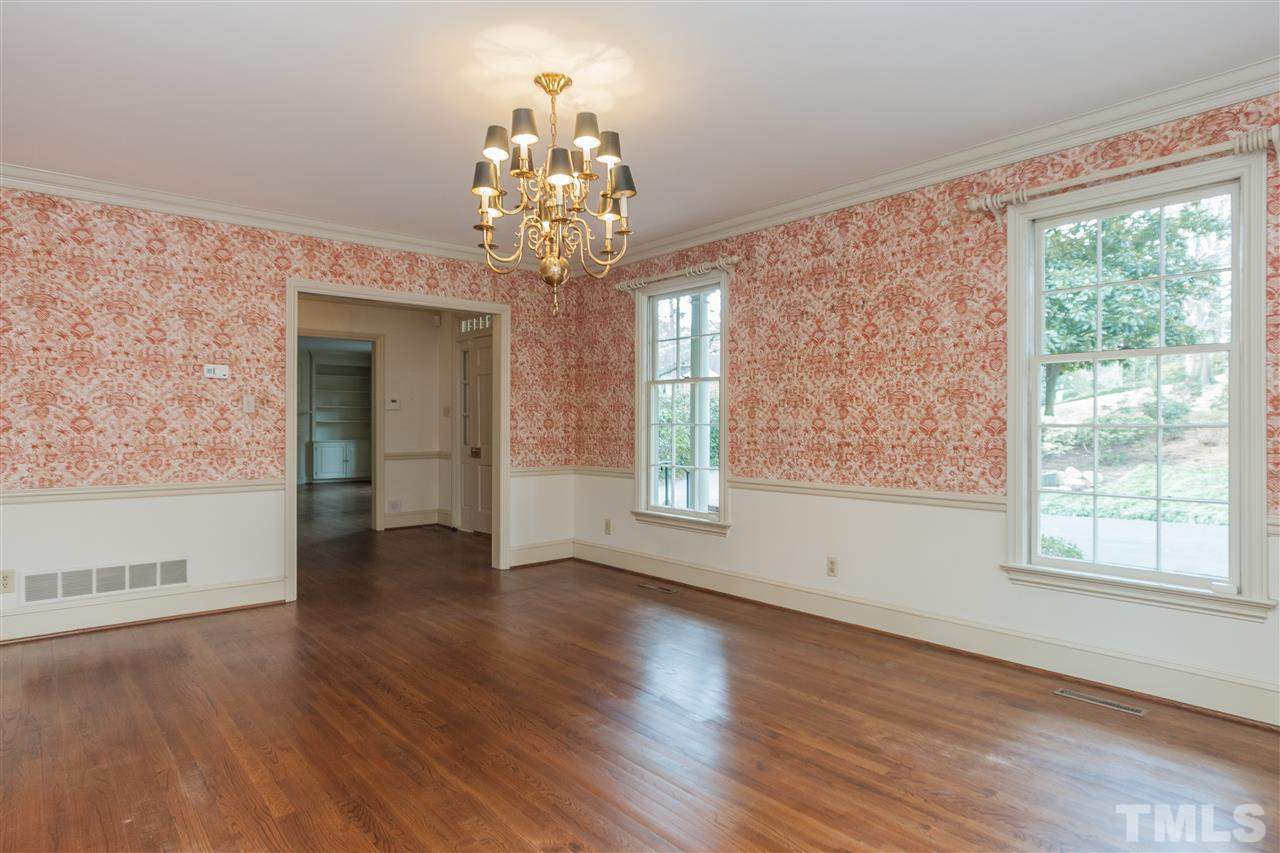 3400 Landor Road Raleigh, NC 27609 - Photo 7 of 25 a view of a room with wooden floors and chandelier