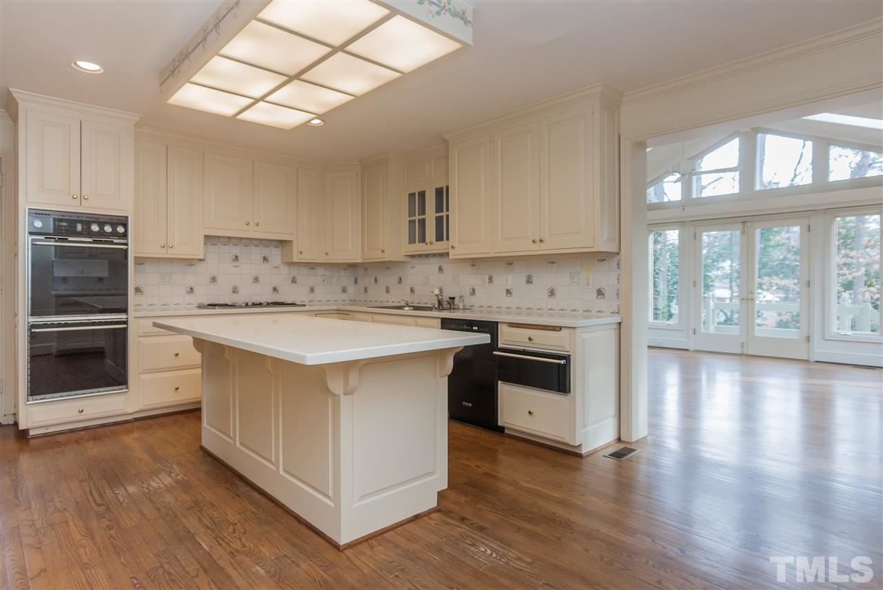 3400 Landor Road Raleigh, NC 27609 - Photo 8 of 25 a kitchen with stainless steel appliances granite countertop a stove a sink and a refrigerator