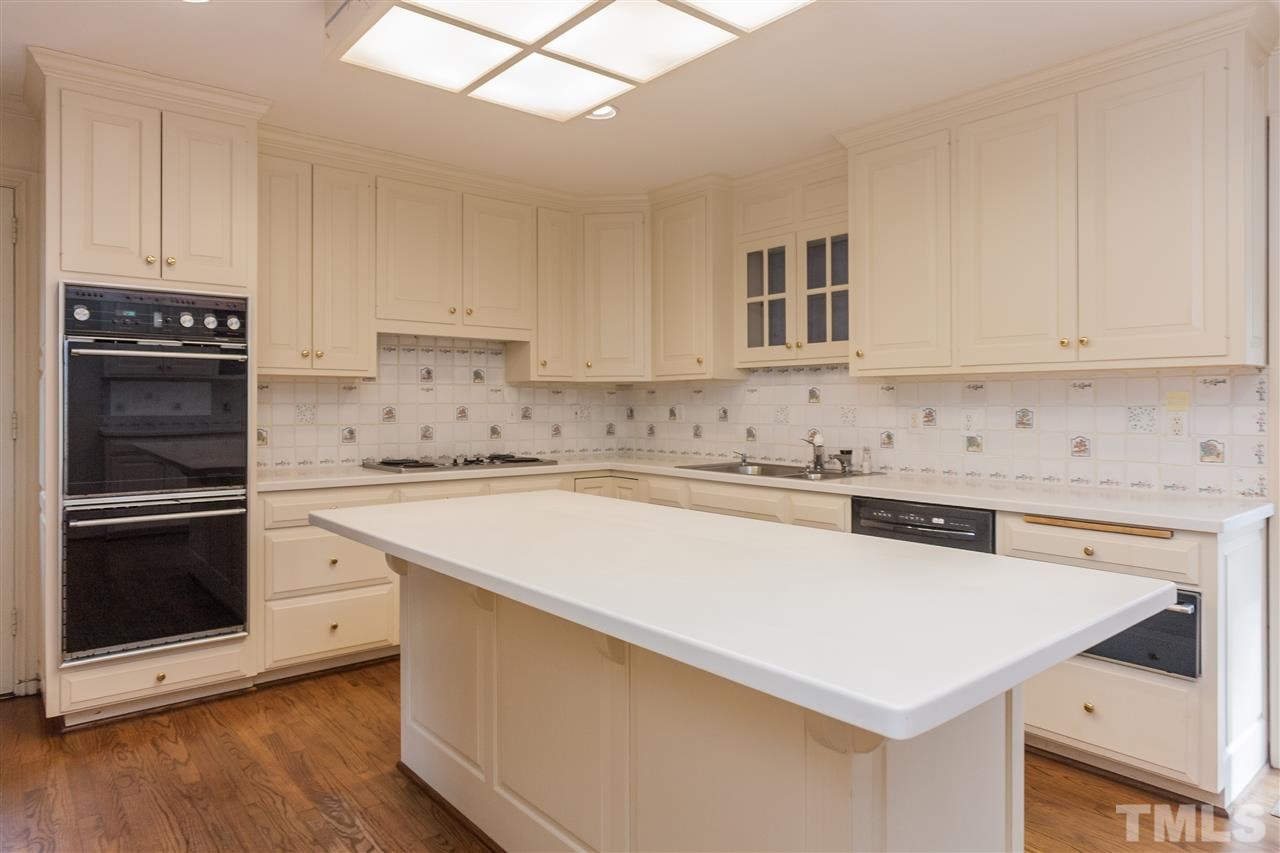 3400 Landor Road Raleigh, NC 27609 - Photo 9 of 25 a kitchen with granite countertop white cabinets and stainless steel appliances