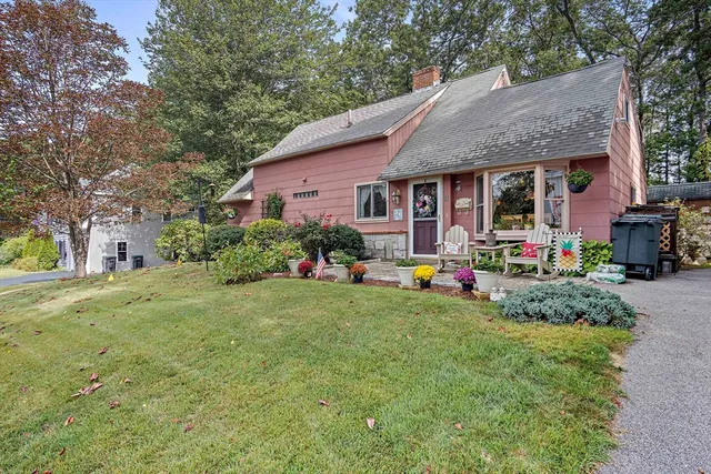 a front view of house with yard and outdoor seating
