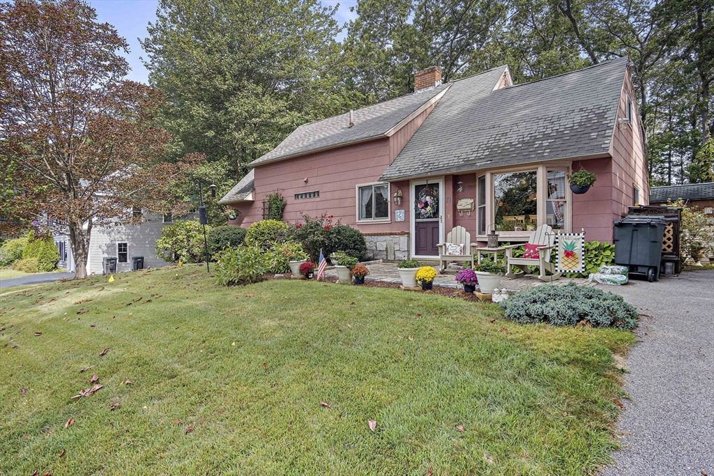 a front view of house with yard and outdoor seating