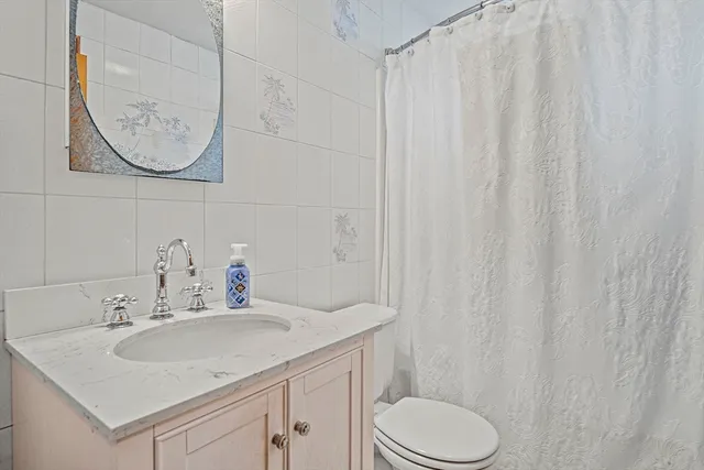 a bathroom with a sink toilet and mirror