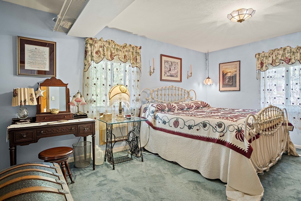 21 Kelsey Road Natick, MA 01760 - Photo 17 of 34 a bedroom with a bed and wooden floor