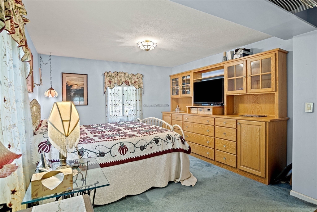 21 Kelsey Road Natick, MA 01760 - Photo 19 of 34 a bedroom with a bed and furniture