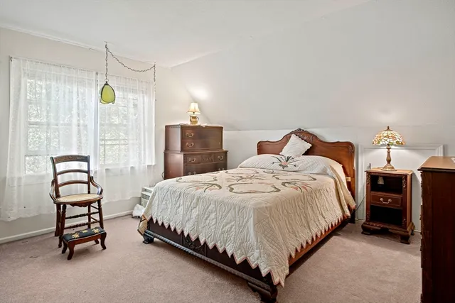 a bedroom with a bed a table and chair