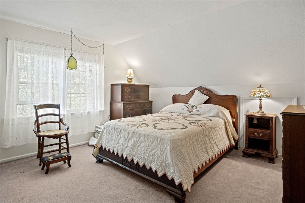 21 Kelsey Road Natick, MA 01760 - Photo 20 of 34 a bedroom with a bed a table and chair