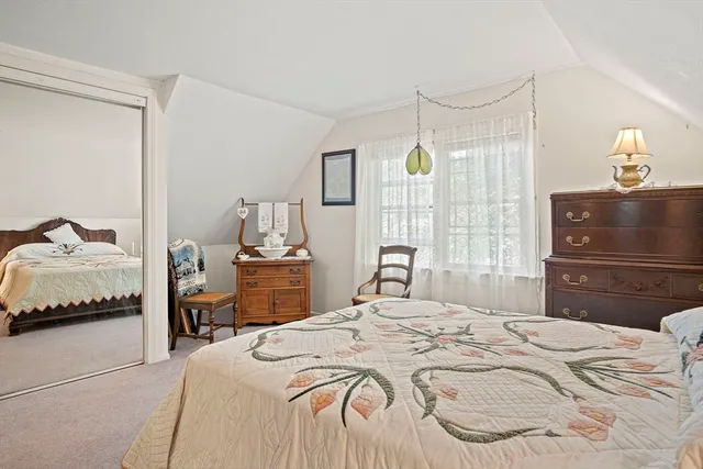 a bedroom with a bed and a mirror