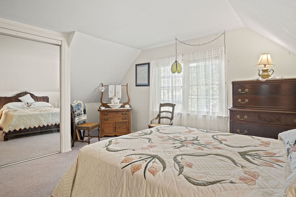 21 Kelsey Road Natick, MA 01760 - Photo 21 of 34 a bedroom with a bed and a mirror