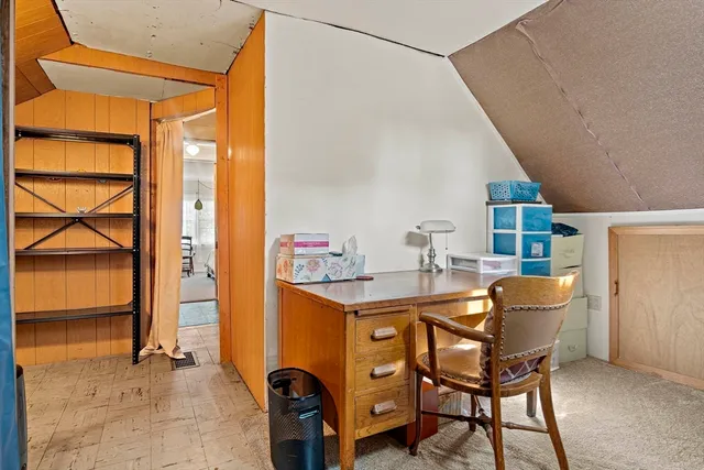 a view of a swimming pool with lawn chairs and a fire pit