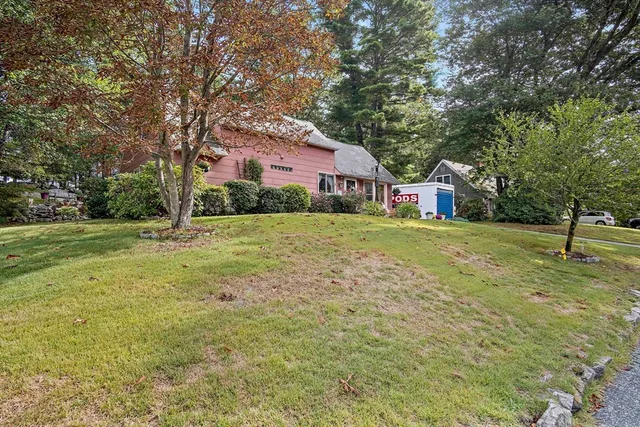 a view of a house with garden and sitting area
