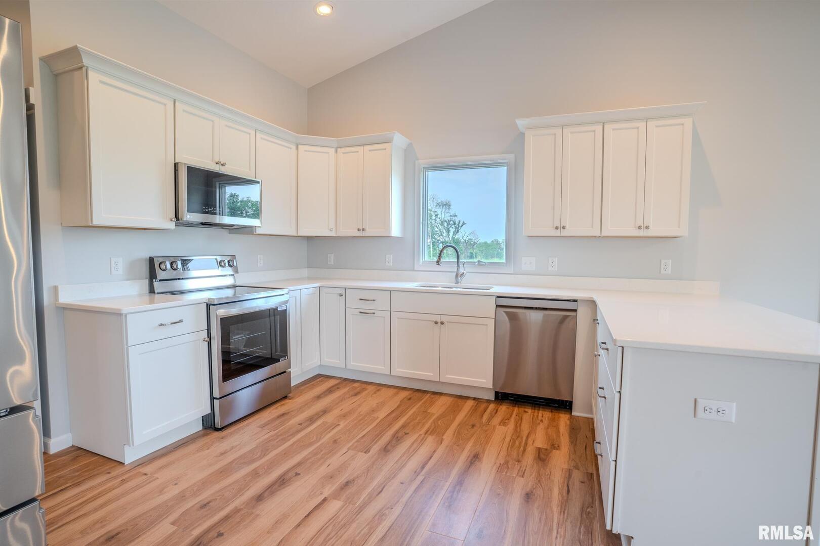 941 9th Avenue North Clinton, IA 52732 - Photo 6 of 24 a kitchen with granite countertop white cabinets and white appliances