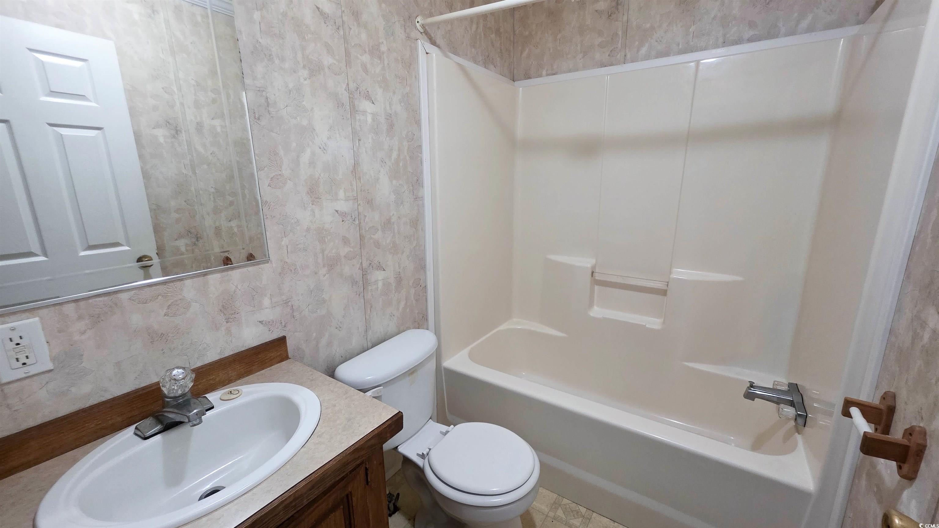 2018 Venus Court Loris, SC 29569 - Photo 14 of 17 Full bathroom featuring wallpapered walls, vanity, and bathing tub / shower combination