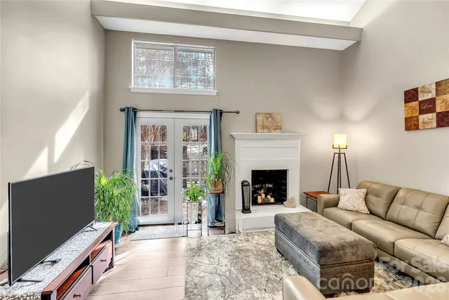 a kitchen with stainless steel appliances granite countertop a refrigerator a stove and a sink with wooden floor