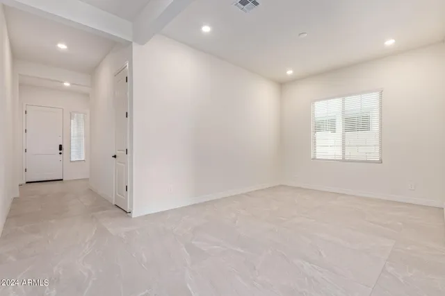 an empty room with windows and closet