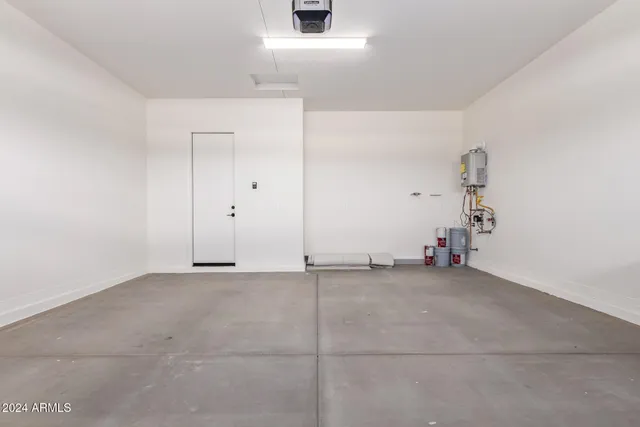 an empty room with cabinet and mirror