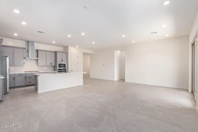 a view of kitchen with kitchen island white cabinets and stainless steel appliances