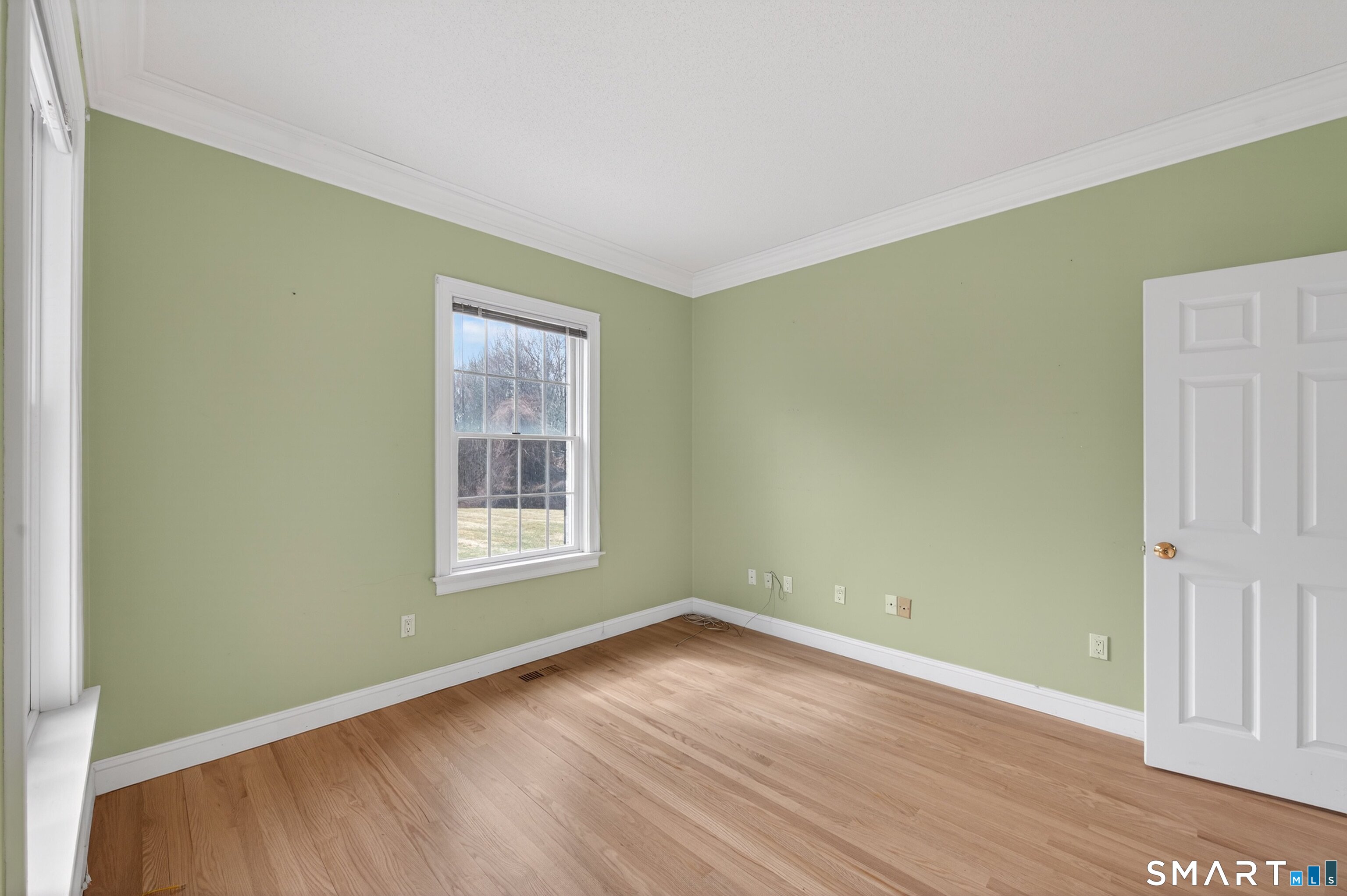 724 Strong Road South Windsor, CT 06074 - Photo 6 of 39 a view of an empty room with wooden floor and a window