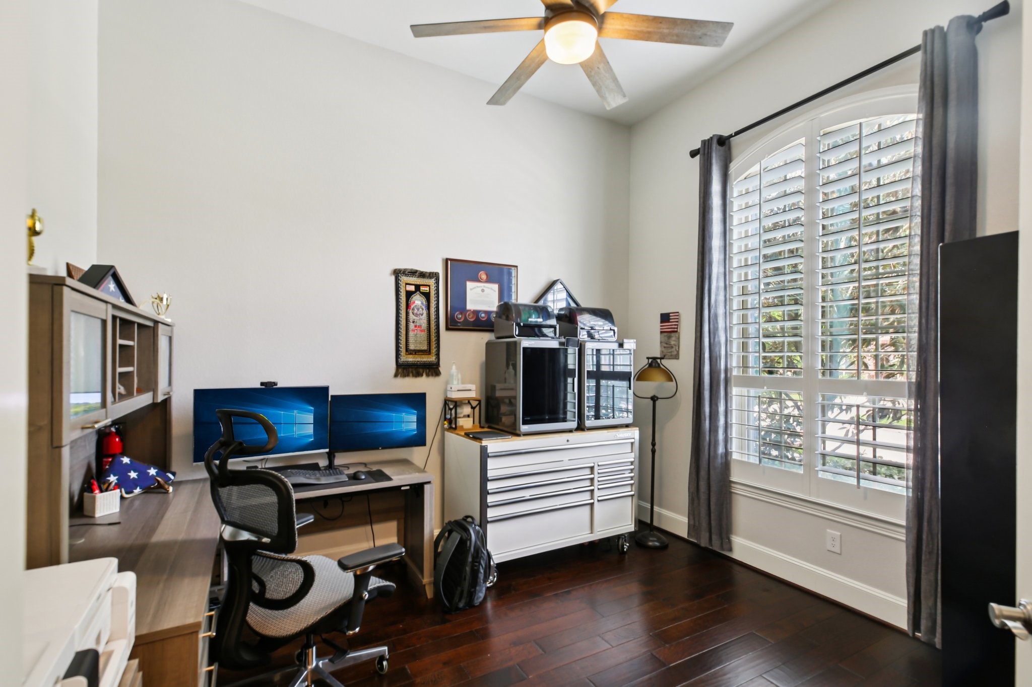 27914 Arden Trail Spring, TX 77386 - Photo 43 of 49 Bright home office with dark hardwood floors, a ceiling fan, and a large window with plantation shutters.