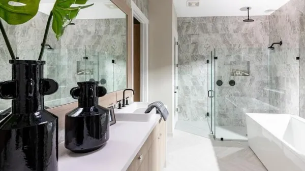 a bathroom with a tub sink and mirror