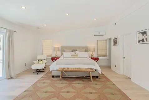 a spacious bedroom with a bed and a window