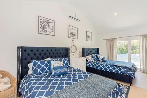 a bedroom with furniture and a large window