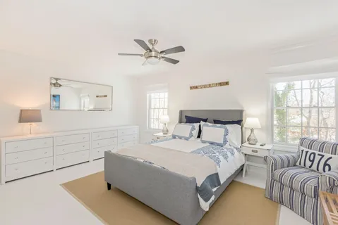 a spacious bedroom with a bed and a couch