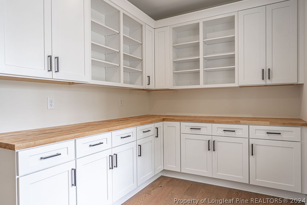 113 Pittman Road West End, NC 27376 - Photo 11 of 50 a view of white cabinets with wooden floors