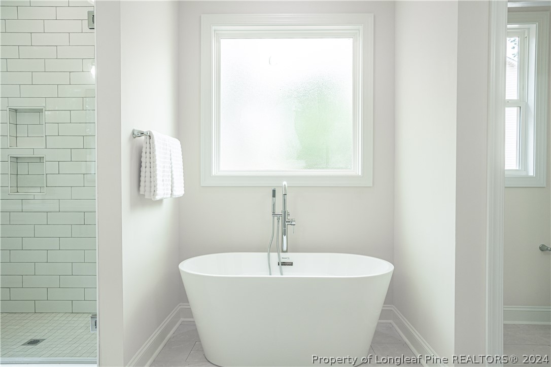 113 Pittman Road West End, NC 27376 - Photo 23 of 50 a bathroom with a white bathtub