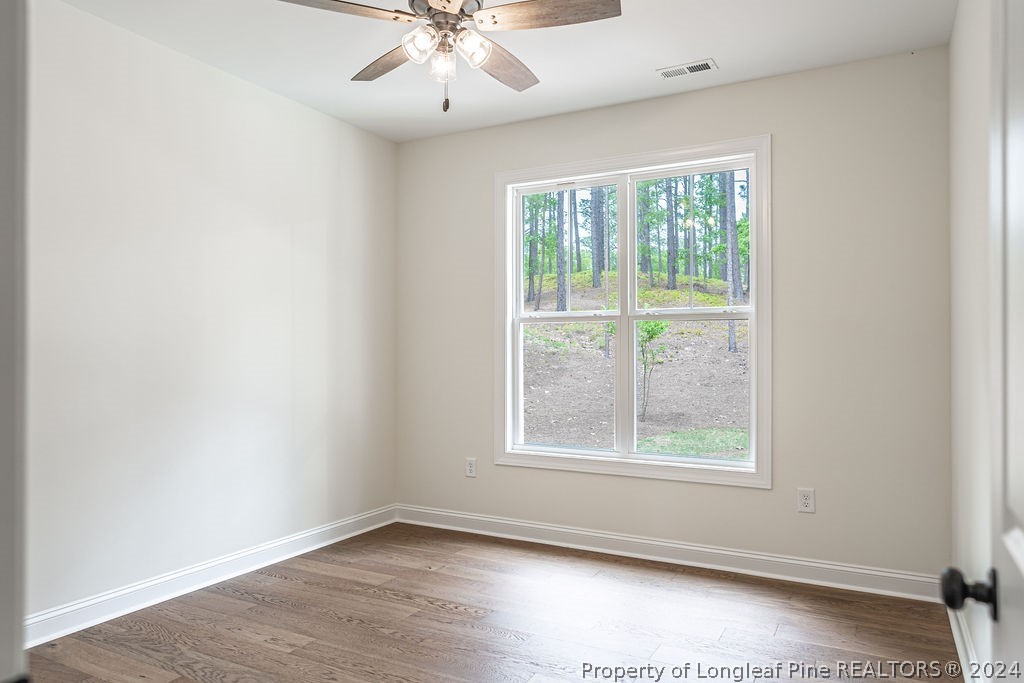 113 Pittman Road West End, NC 27376 - Photo 33 of 50 an empty room with wooden floor and windows