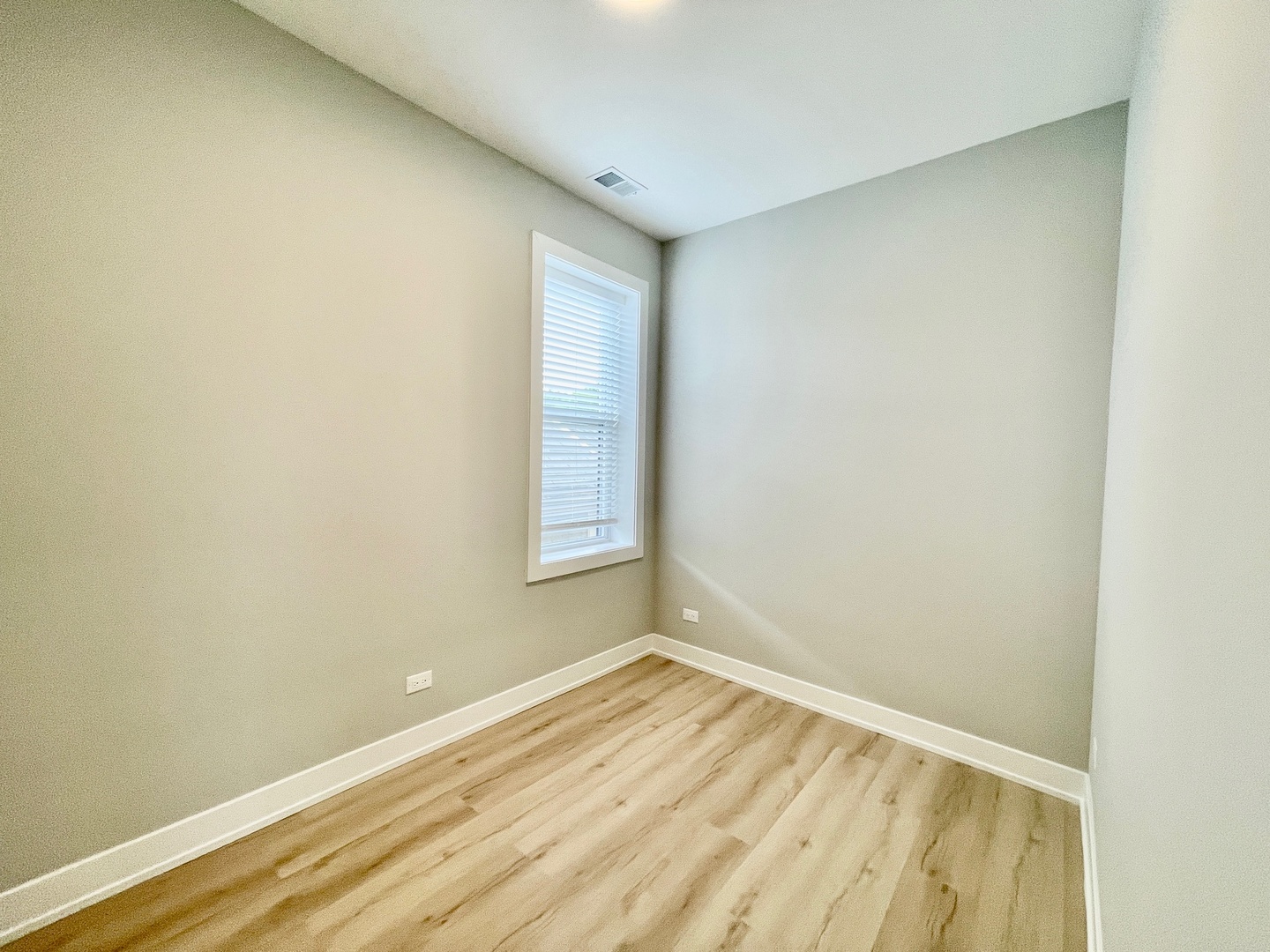 2238 West 24th Street, Unit 2F Chicago, IL 60608 - Photo 11 of 25 an empty room with wooden floor and windows