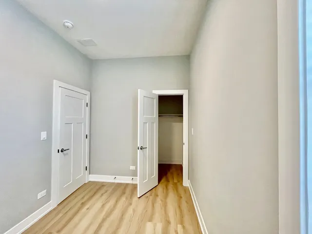 a view of a room with wooden floor and a sink