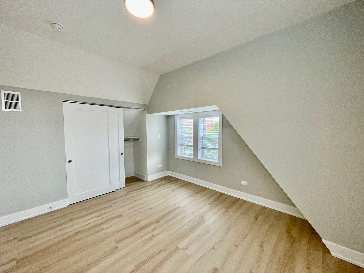 2238 West 24th Street, Unit 2F Chicago, IL 60608 - Photo 18 of 25 a view of an empty room with wooden floor and a window
